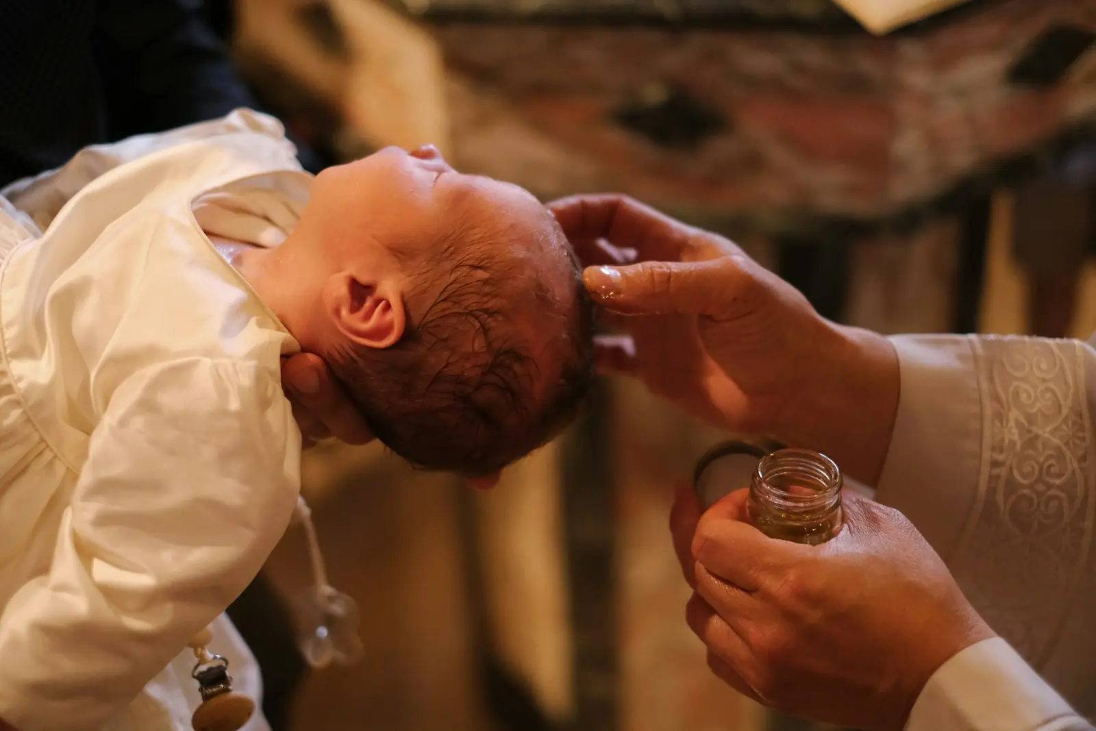 Bebé con faldón blanco en su bautizo, celebración familiar en una finca en Madrid